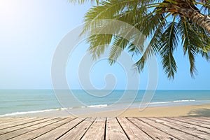 Empty wooden terrace over tropical island beach with coconut palm