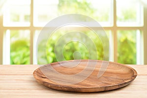 Empty wooden tray on perspective wooden table on top over blur b