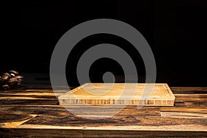 empty wooden tray plate wooden table with dark isolate background textspace