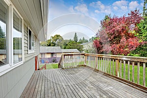 Empty Wooden walkout deck overlooking backyard garden