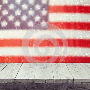 Empty wooden white table over USA flag bokeh background. USA national holidays background. 4th of July celebration.