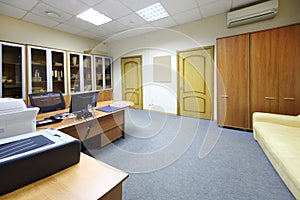 Empty working area with desktop, bookcase in modern office