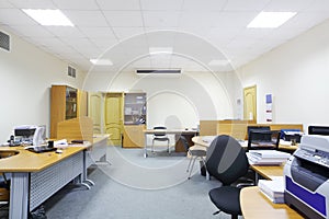 Empty working areas with armchairs and tables