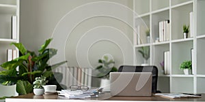 Empty workplace with desk and plant in office room, copy space. work from an atmospheric home office full of green plant