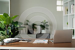 Empty workplace with desk and plant in office room, copy space. work from an atmospheric home office full of green plant