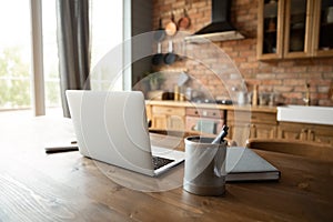 Empty workplace with laptop in home kitchen office
