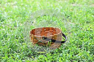 An empty woven basket on the green grass