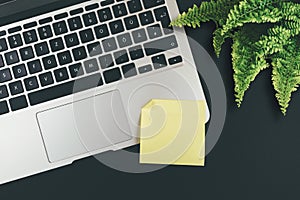 Empty yellow adhesive note on laptop keyboard