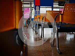 Empty yellow chairs in bus station