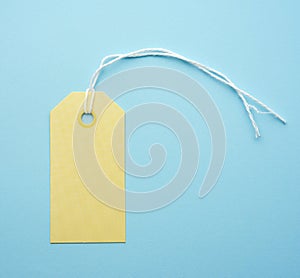 Empty yellow paper tag tied with white string