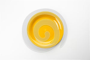Empty yellow plate isolated on white background