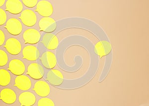 Empty yellow speech bubbles on beige background. Small paper stickers