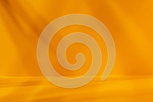 Empty yellow studio space with deep artistic shadow