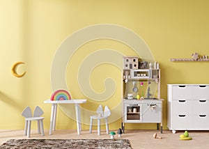 Empty yellow wall in modern child room. Mock up interior in scandinavian style. Copy space for your picture or poster