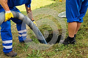 Emptying household septic tank.