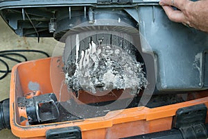 Emptying a shop vacuum. Finding out you forgot to replace the vacuum bag before using