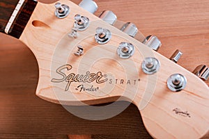 EMPURIABRAVA, SPAIN - FEBRUARY 17, 2021 Guitar headstock of Fender Squier Strat with logo closeup