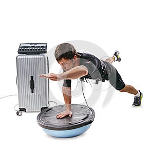 EMS fitness man doing side plank with toe touch on bosu ball