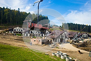 Emtpy chairlift in ski resort. Mountains and hills with in Summer with green trees