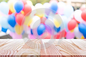 Emtry wooden table on top over blur balloon background, can be used mock up for montage products display or design layout