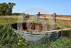 Emty watering stock tank in a former feedlot