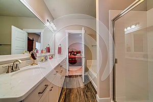 En suite bathroom with double sink vanity built in bathtub and shower stall