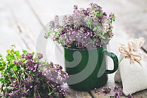 Enameled mug of thyme flowers. Herbal medicine.