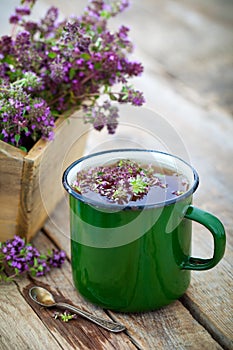 Enameled mug of thyme healing herbs.