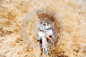Enamored girl and the guy hugging in a field