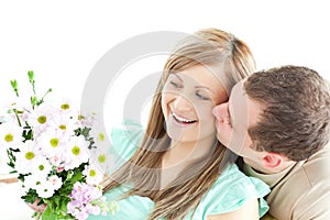 Enamored man giving a bouquet to his girlfriend