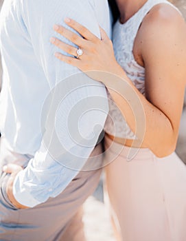 Enamored man and woman embracing, woman hugging man& x27;s shoulders, close-up