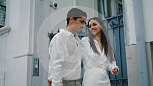 Enamoured pair strolling city street close up. Cheerful girl dating boyfriend