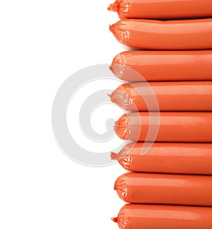 Encased sausages on white background, top view with space for text.