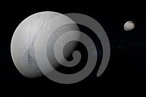 Enceladus and Iapetus moons orbiting in the outer space. 3d render photo