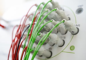 Encephalograph with green and red wires at modern medical center