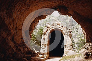 Enchanted portal in ancient stone arch fairytale background. Mysterious place in rock cliff tunnel with way to other