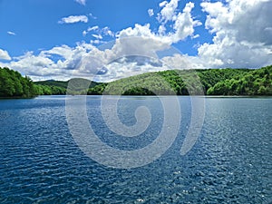 An enchanting glassy surface of the mountain lake inherits the blues of the sky