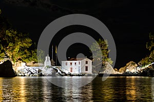 Enchanting Night View of Holy Mary Island in Parga Greece. White Chapel with Belfry Surrounded by Trees. Amazing Night Photography