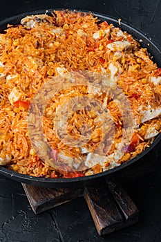 Enchilada with tomato rice, a mexican recipe, on black background