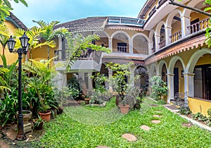 Enclosed Courtyard with Trees and Wooden Bench photo