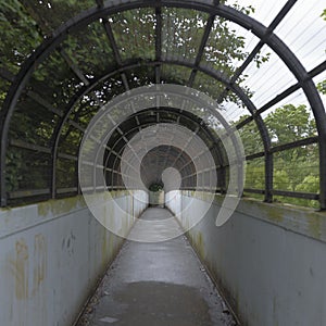 An enclosed pedestrian bridge over railway tracks