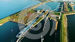 Enclosure Dam (Afsluitdijk): Large Cargo Ship Navigating the Narrow Sluice - Friesland, The Netherlands – 4K Drone