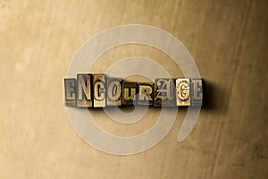 ENCOURAGE - close-up of grungy vintage typeset word on metal backdrop