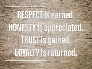 Encouragement quote of respect is earned honesty is appreciated trust is gained loyalty is returned. Written on wooden surface. photo
