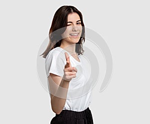 Encouraging gesture woman pointing finger winking