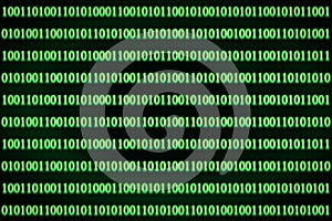 Encrypted binary ASCII computer code on black background. Green binary code computer photo