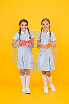 Encyclopedia book for children. small girls love literature. old school. happy friends in retro uniform. vintage kid