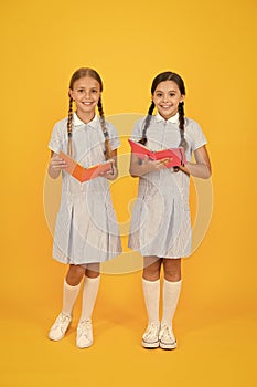 Encyclopedia book for children. small girls love literature. old school. happy friends in retro uniform. vintage kid