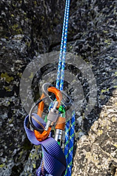 Rappel down on the climbing rope using a descender. photo