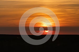 The end of the day just before the sunsets on the horizon with an amazing orange glow in riemst near Maastricht